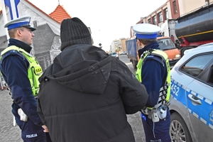 Policjanci z drogówki w trakcie legitymowania pieszego.